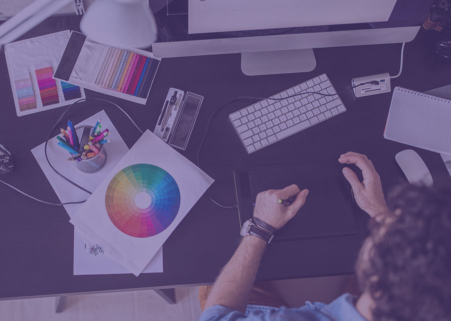 Woman at a desk with a computer and color wheel